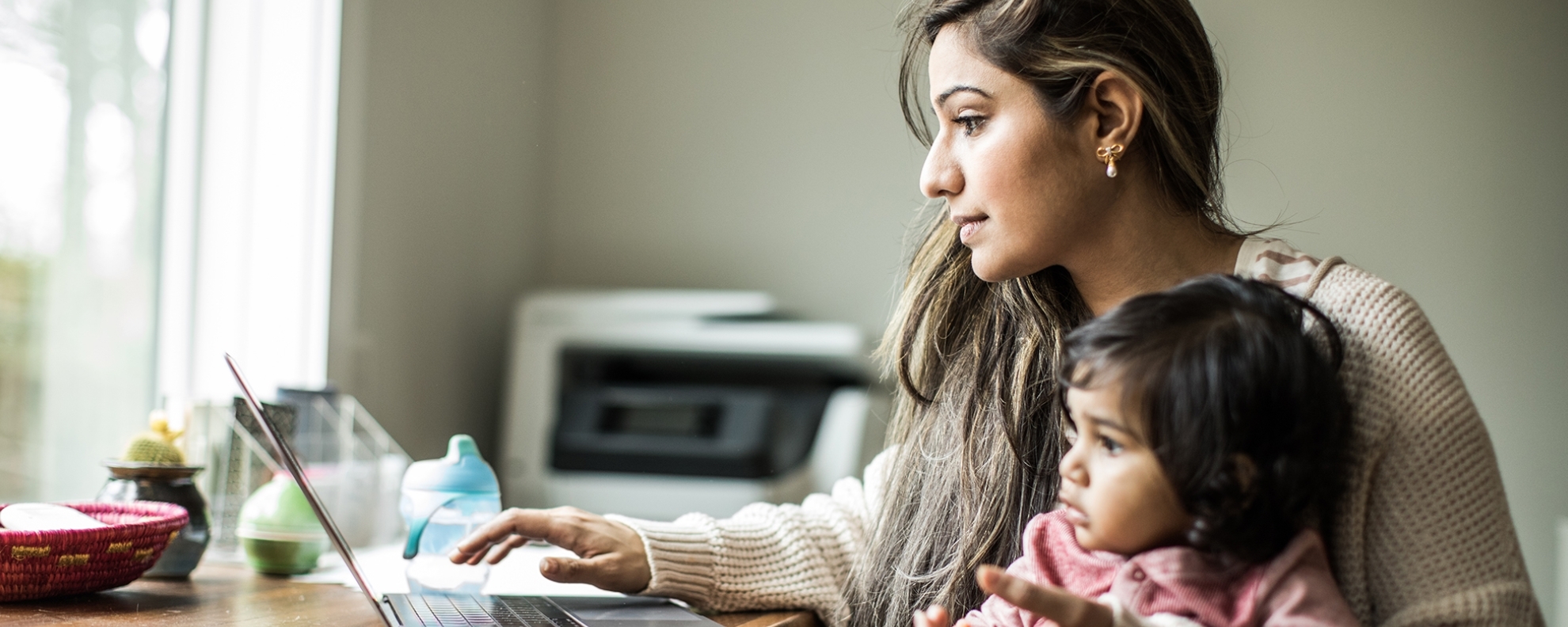 Woman Working On Laptop Kid On Lap